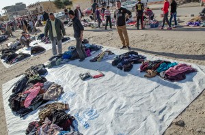 Sorting clothing at a Yezidi camp.