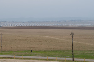 Tents in a formal camp, which was formerly farmland. In the background is Mosul Dam reservoir.